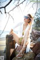 A woman sitting on a rock on the beach.