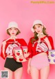 A couple of women standing next to each other holding baskets.