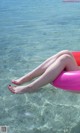 A woman laying on an inflatable ring in the water.